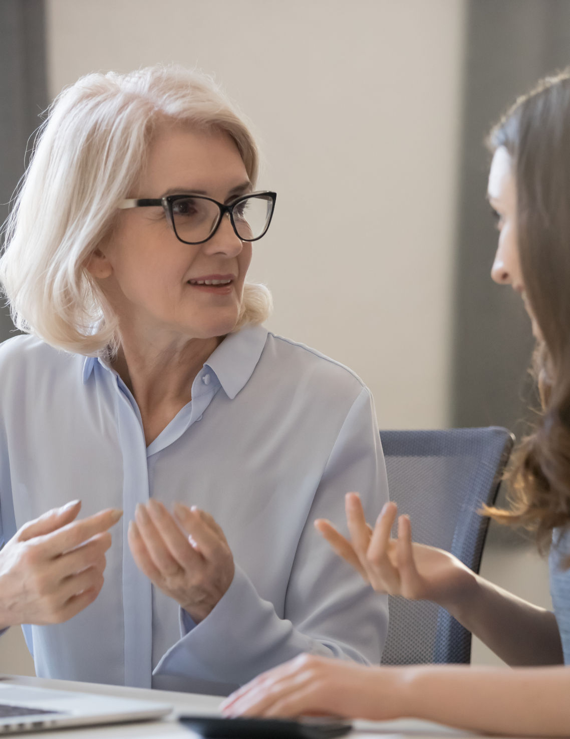 Elderly woman talking with a financial professional