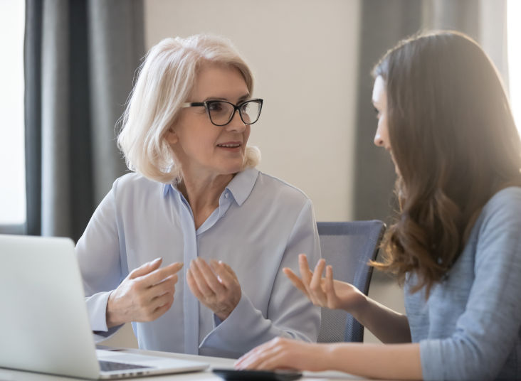 Elderly woman talking with a financial professional